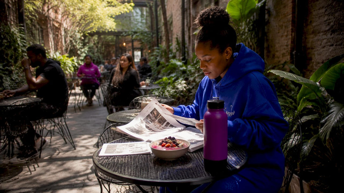 Woman researching streetwear cultural references at café