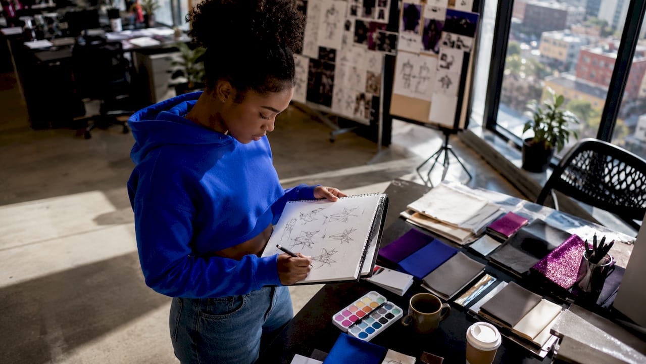Designer sketching clothing brand identity logos