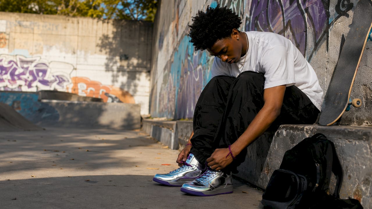 Man styling unreleased streetwear sneakers outdoors