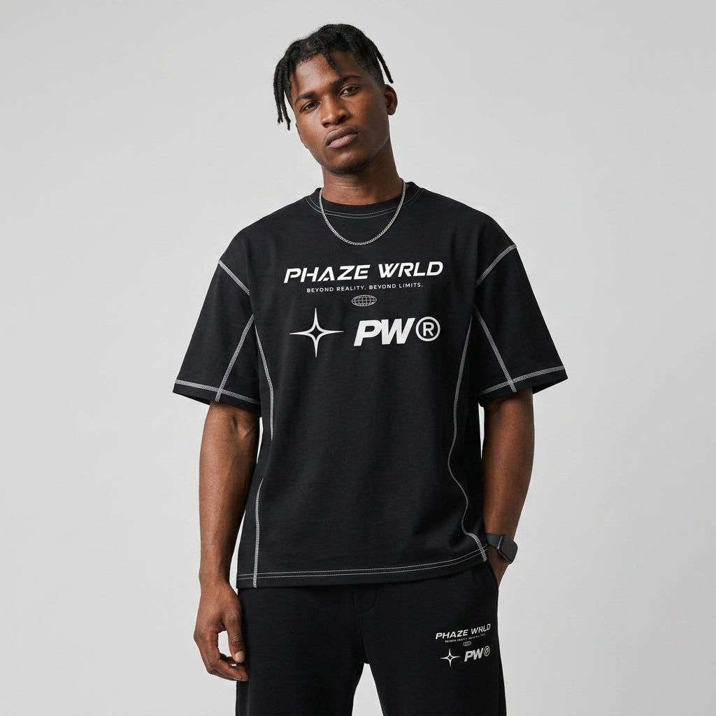 Black oversized boxy streetwear t-shirt with white contrast stitching and a futuristic white Phaze Wrld graphic printed on the chest.