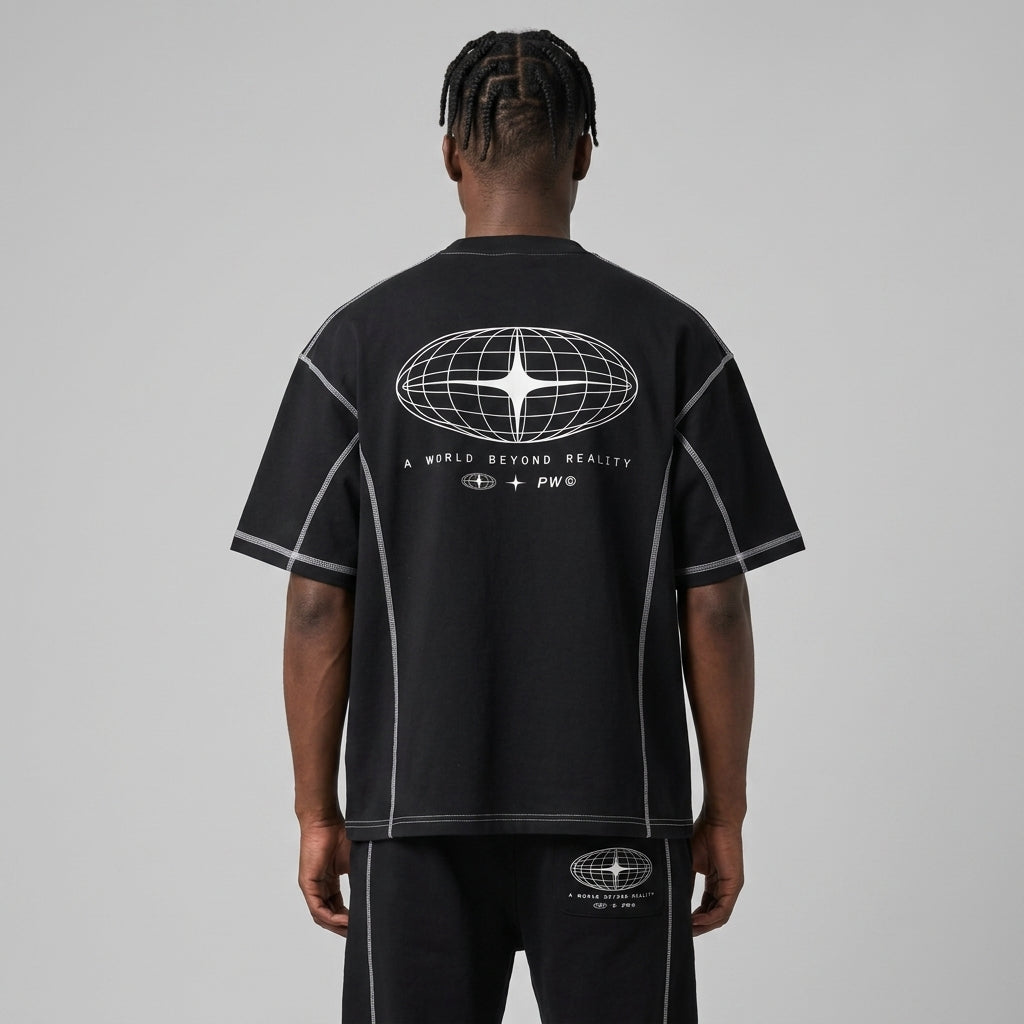 Back view of a premium black oversized streetwear t-shirt featuring white contrast stitching and a futuristic globe graphic on the back.