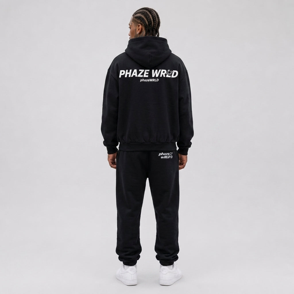 Back view of a premium black oversized streetwear hoodie featuring a bold white "Phaze Wrld" graphic print across the shoulders.