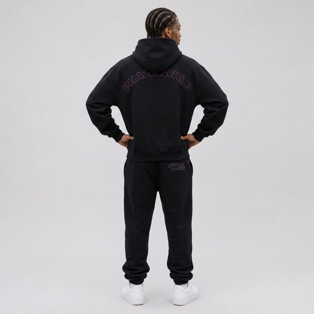 Back view of a premium black oversized streetwear hoodie featuring a purple arched outline PHAZEWRLD graphic across the shoulders.
