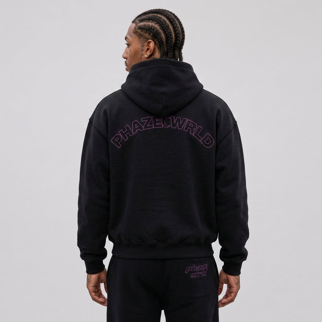 Back view of a premium black oversized streetwear hoodie featuring a purple arched "PHAZEWRLD" outline logo graphic on heavyweight fleece.