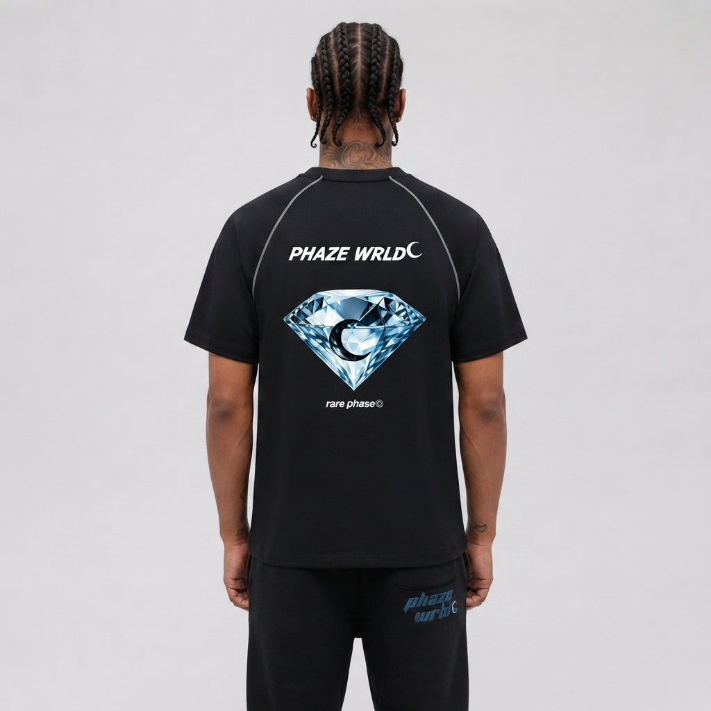 Back view of a premium black short-sleeve raglan streetwear t-shirt featuring a blue diamond graphic and silver contrast stitching.