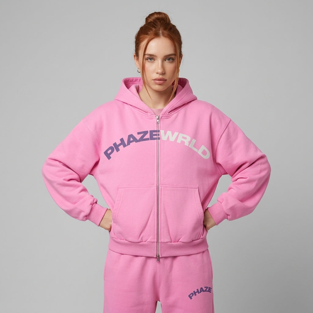 Premium bubblegum pink oversized full-zip streetwear hoodie featuring a color-split arched PHAZEWRLD graphic across the chest.