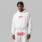 Model wearing the Every Phase white boxy hoodie and matching sweatpants, showing the red oval chest logo.