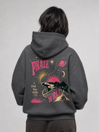 Model showing the back of the dark gray hoodie with its large, vibrant celestial graphic print.