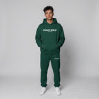 A premium forest green oversized streetwear hoodie featuring a bold white graphic on the chest, dropped shoulders, and a kangaroo pocket.