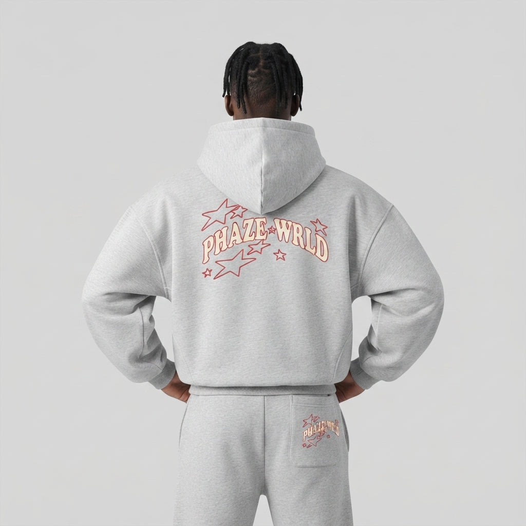Back view of a premium heather grey oversized streetwear hoodie with a red and cream arched Phaze Wrld star graphic, styled in a boxy cropped fit.
