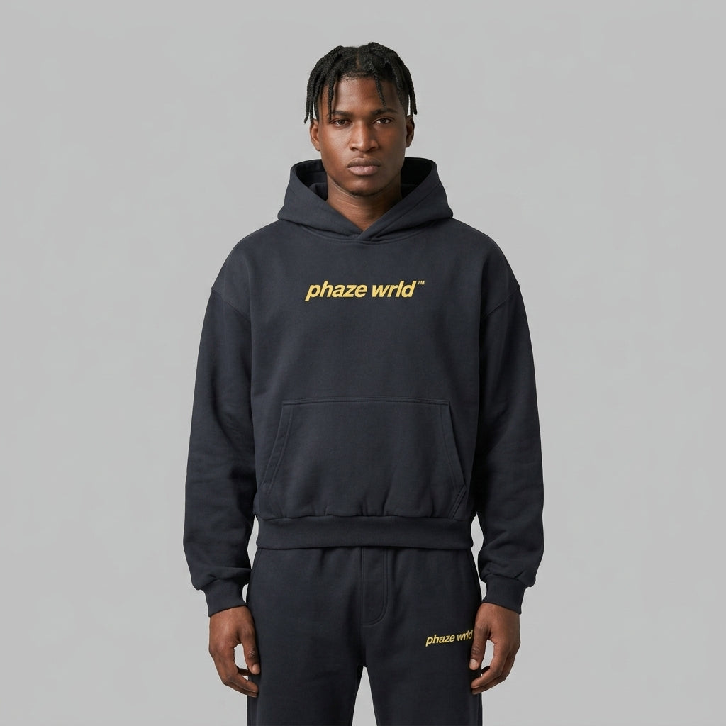 Front view of a premium dark navy oversized streetwear hoodie featuring a yellow outlined PHAZEWRLD logo on the upper back.