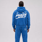 Close-up on the back of a model wearing the Lapis Blue Stellar Boxy Hoodie, highlighting the 'PHAZE WRLD' graphic.