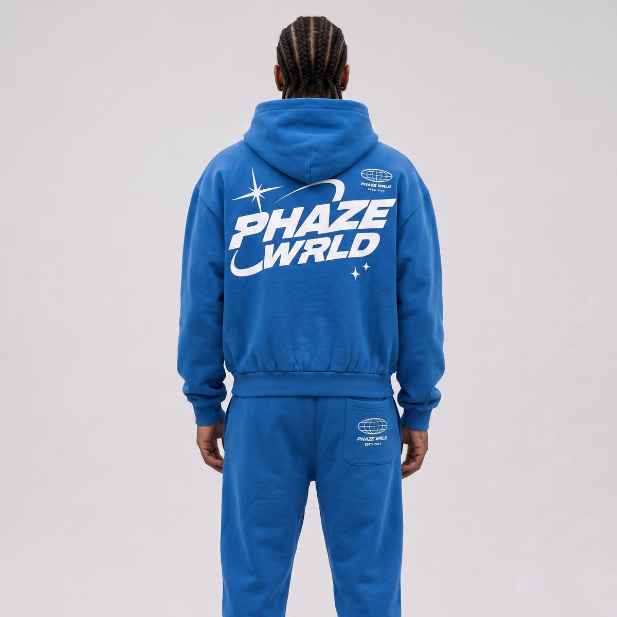 Close-up on the back of a model wearing the Lapis Blue Stellar Boxy Hoodie, highlighting the 'PHAZE WRLD' graphic.