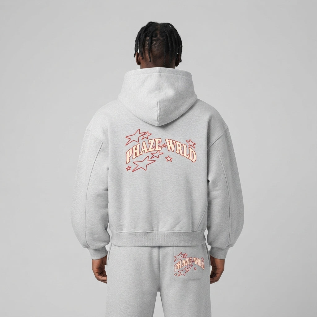 Back view of a premium light heather grey oversized streetwear hoodie featuring a red arched PHAZE WRLD graphic and star outlines.