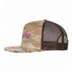 Side view of the flat-brim Multicam Arid/Brown Trucker Cap with a pink 'EXWRLD 09' side graphic.