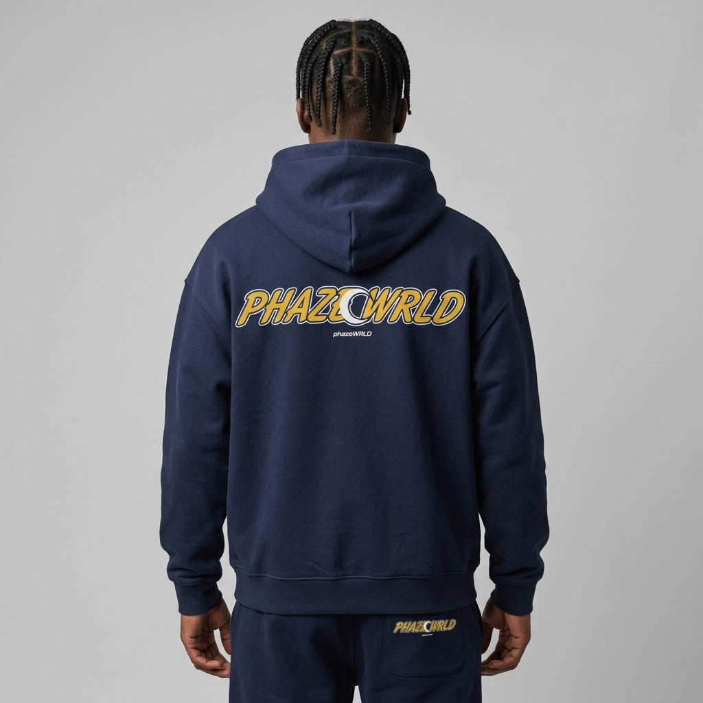 Back view of a premium navy blue oversized streetwear hoodie featuring a yellow arched PHAZEWRLD varsity graphic with a crescent moon detail.