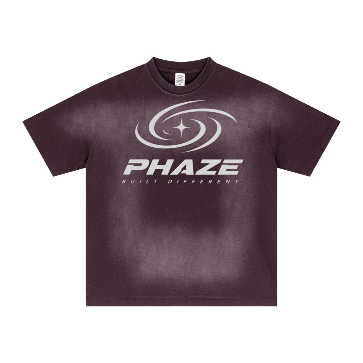Purple streetwear oversized t-shirt featuring a futuristic silver PHAZE swirl graphic and "Built Different" text. Heavyweight cotton boxy fit.