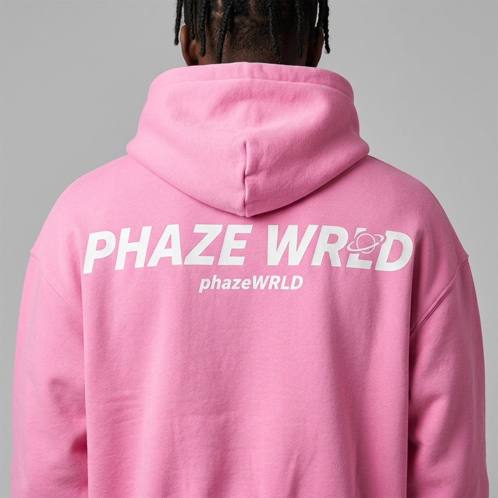 Back view of an oversized bubblegum pink premium streetwear hoodie featuring a bold white PHAZE WRLD graphic print and a relaxed drop-shoulder fit.