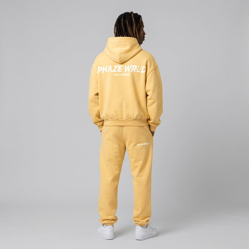 Back view of a premium butter yellow oversized streetwear hoodie featuring white Phaze Wrld graphic text on heavyweight fleece cotton.