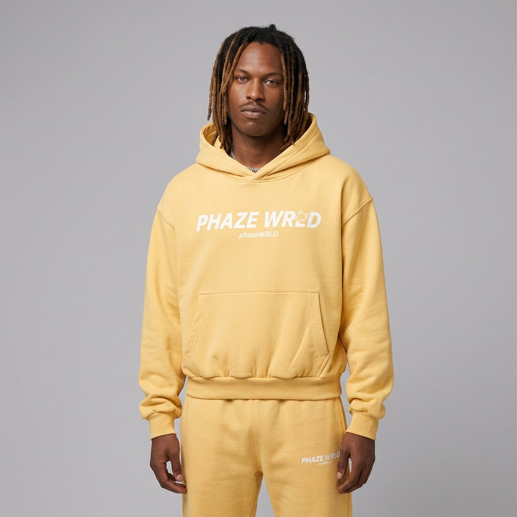  premium buttercream yellow oversized streetwear hoodie featuring a white Phaze Wrld graphic text on heavyweight fleece cotton.