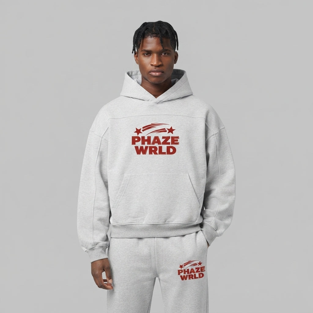 A premium light heather grey oversized streetwear hoodie featuring a boxy fit and a bold red arched PHAZE WRLD chest graphic.