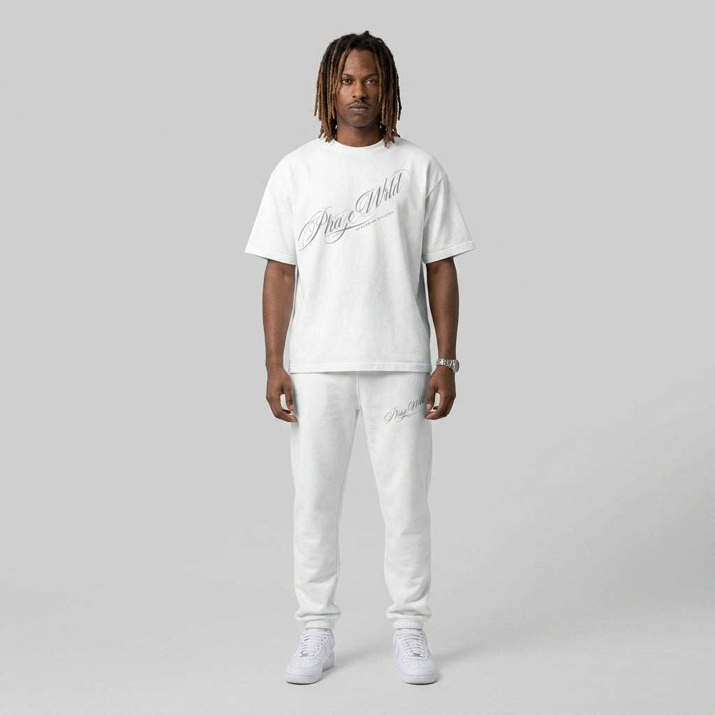A premium white relaxed-fit streetwear t-shirt featuring a diagonal grey script graphic reading Phaze Wrld with a structured ribbed crewneck.