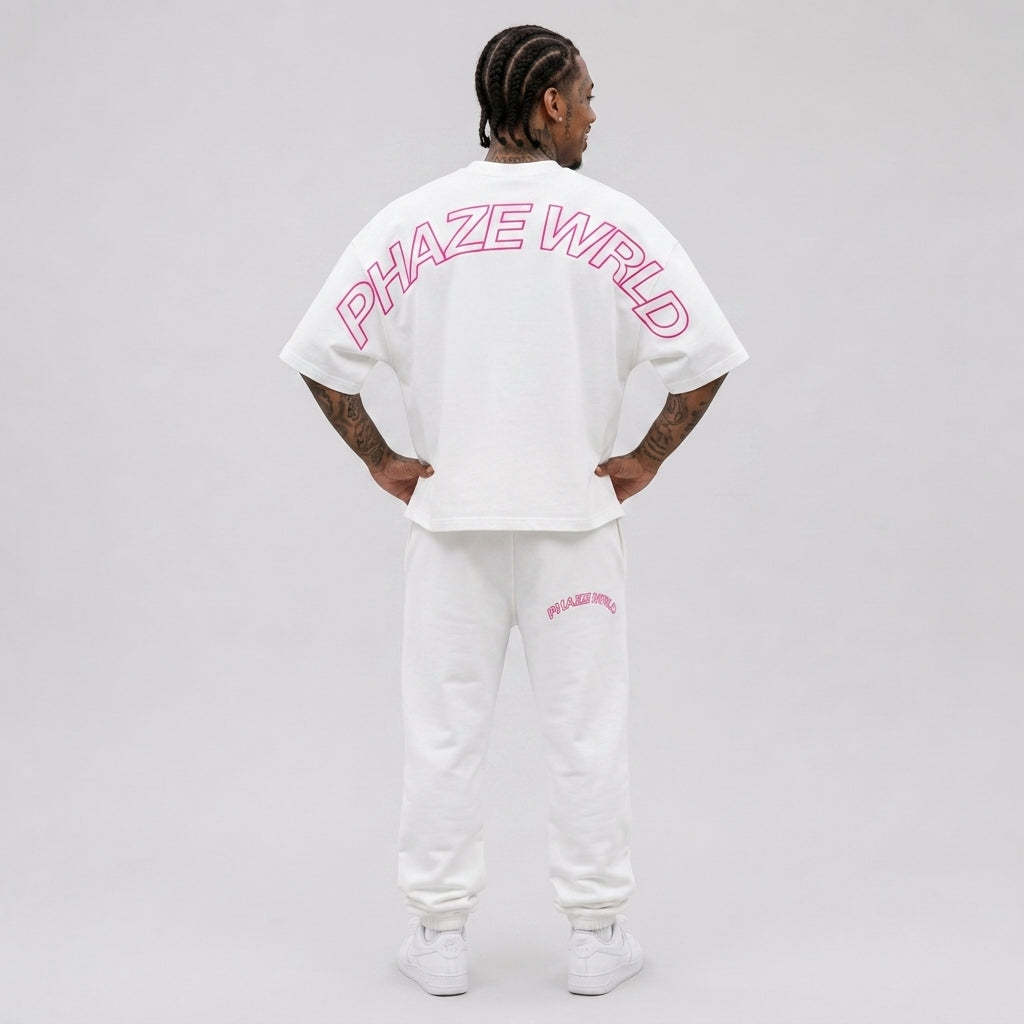 Back view of a premium white oversized boxy streetwear t-shirt featuring a vibrant pink arched outline "PHAZE WRLD" graphic across the shoulders.
